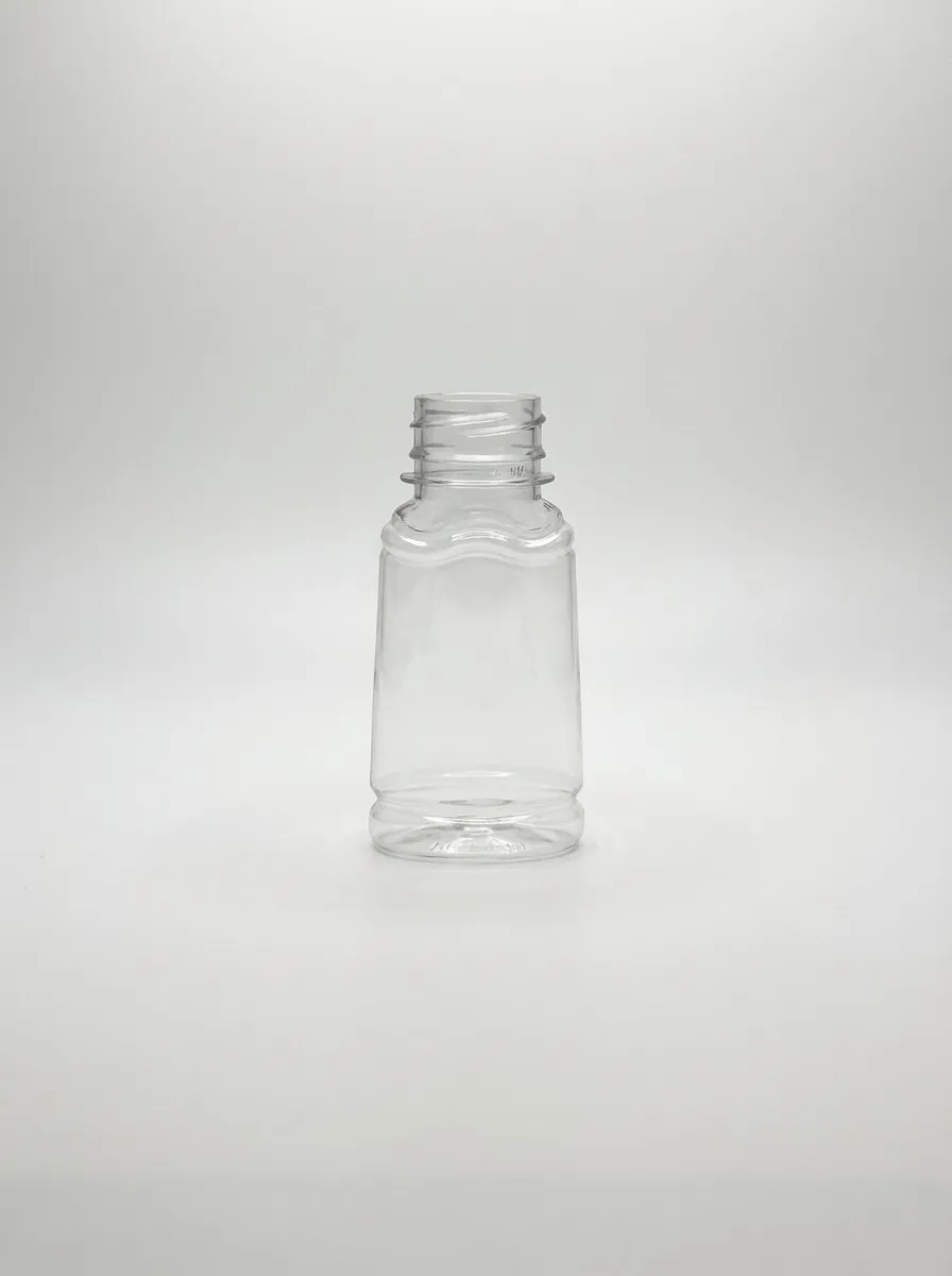 Small clear PET bottle with wavy shoulder and tapered body